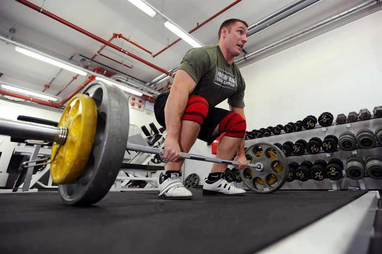 man lifting weights