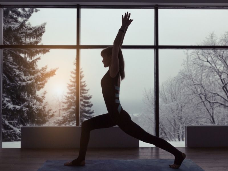 woman doing yoga during winter